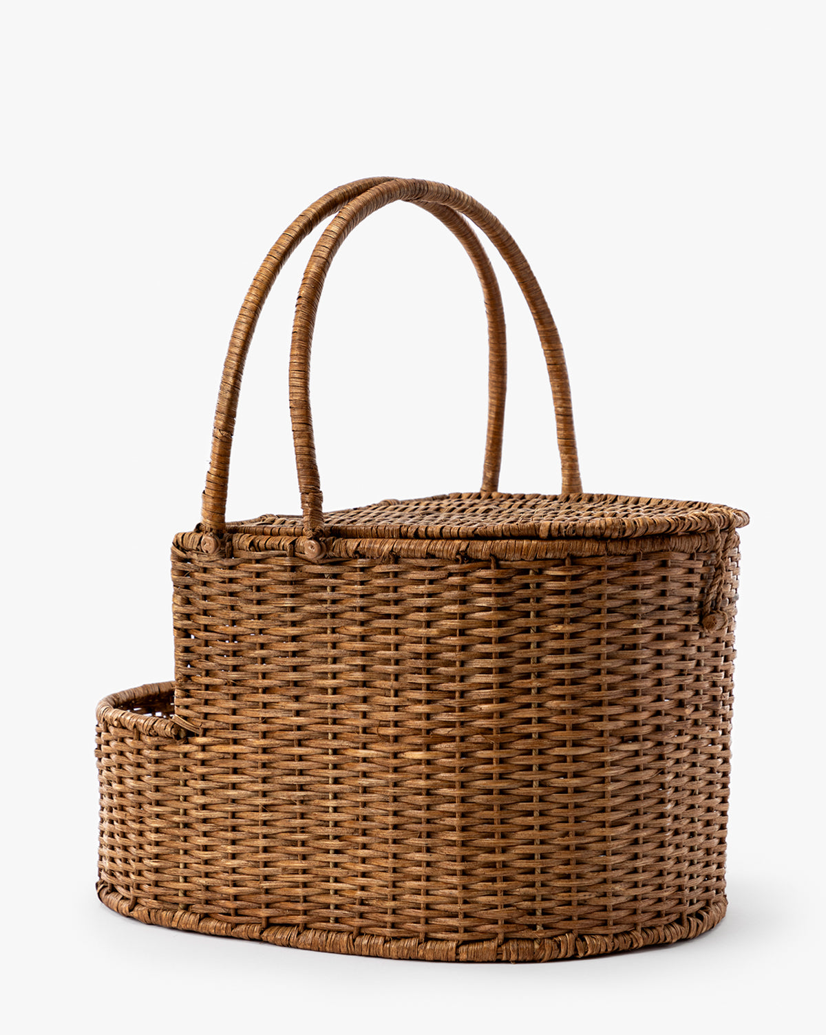 The Rattan Wicker Picnic Basket features a curved lid, two tall handles, and an attached side compartment, shown against a plain white background, by Vendixs