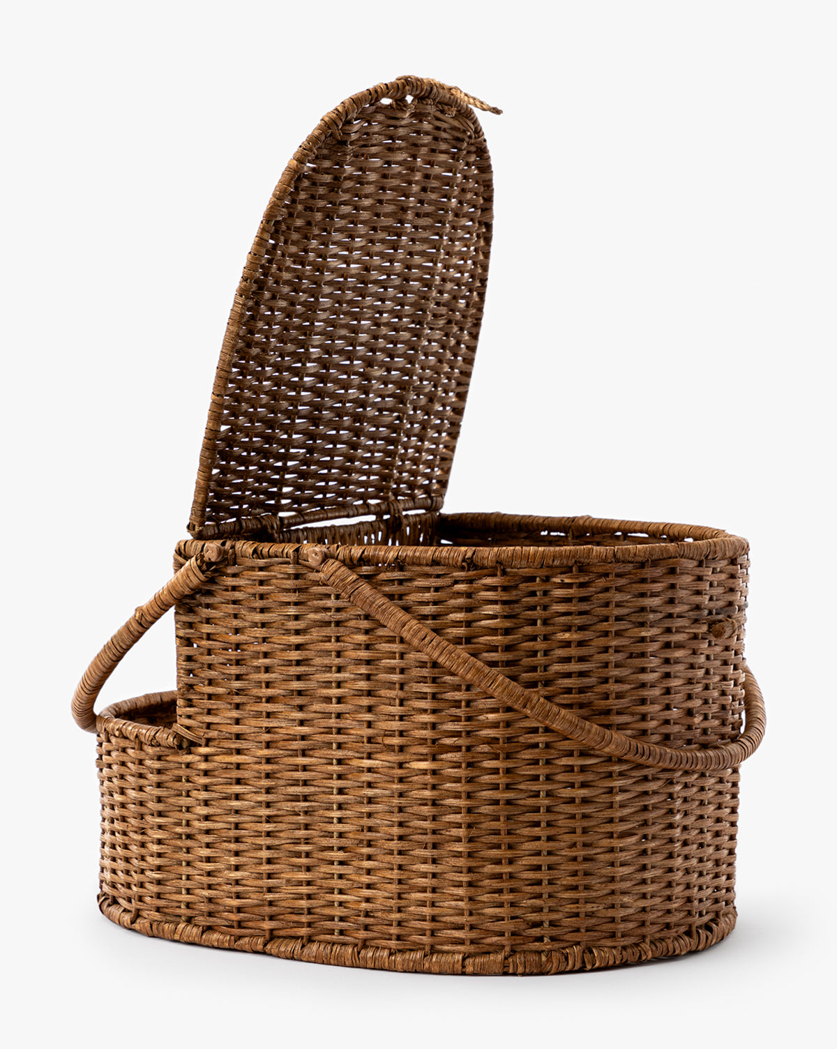 The Rattan Wicker Picnic Basket features an oval shape, hinged lid partially open, and two side handles—ideal for picnics or home organization, by Vendixs Displayed on a plain white background.