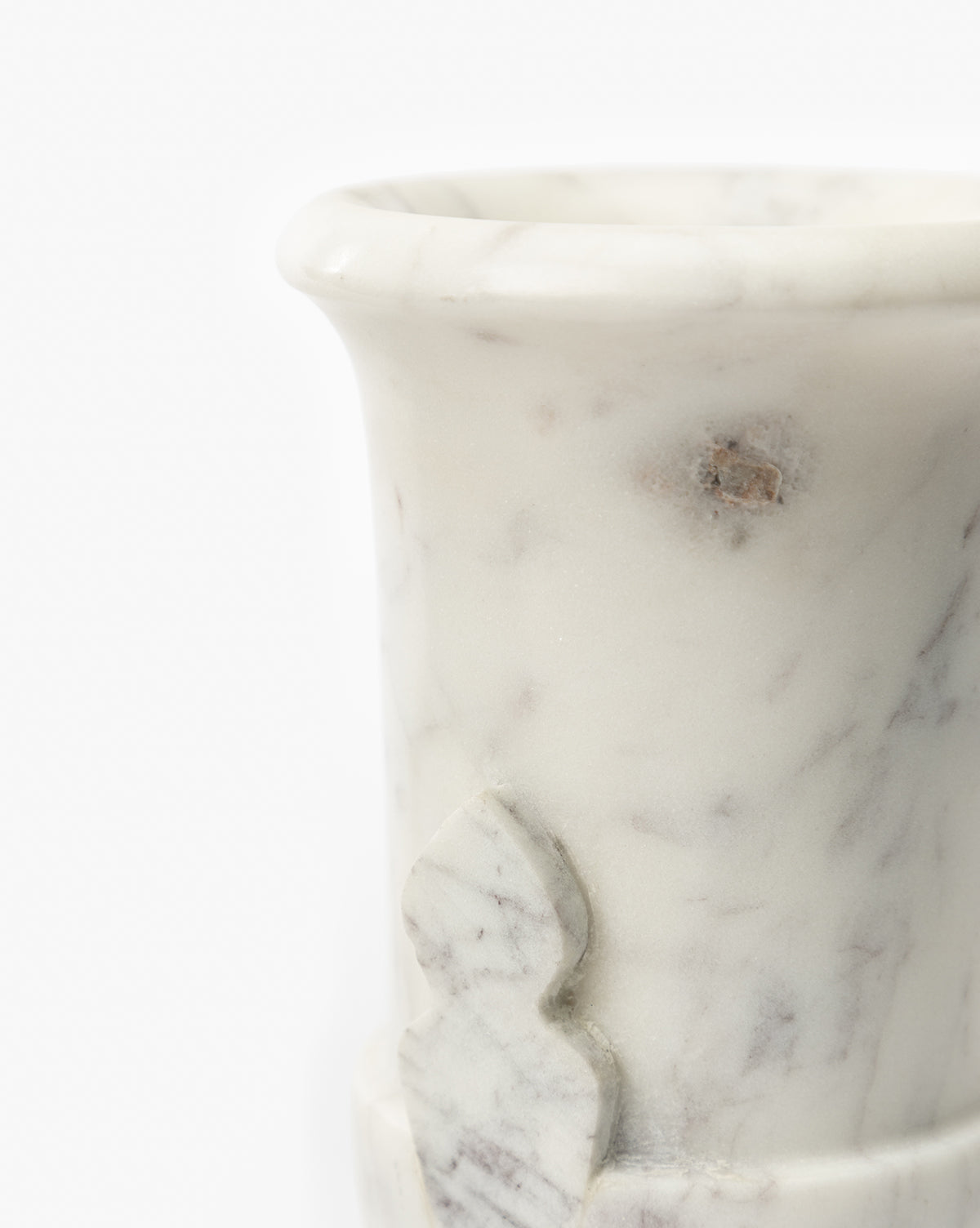 A close-up of the Rayla Marble Vase shows its white marble with grey veins, part of the rim and body, and a small decorative carving—perfect for adding traditional charm to any decor, by Vendixs