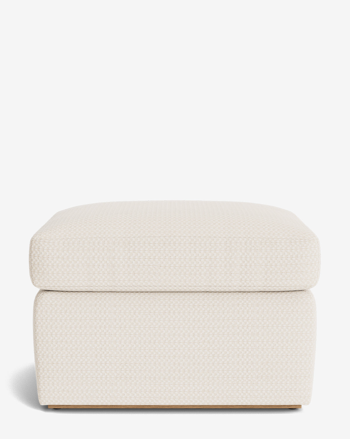 The Reese Ottoman is a handcrafted rectangular ottoman in light beige, featuring a subtle textured pattern and a plush down-wrapped cushion, displayed front-facing against a white backdrop, by Vendixs