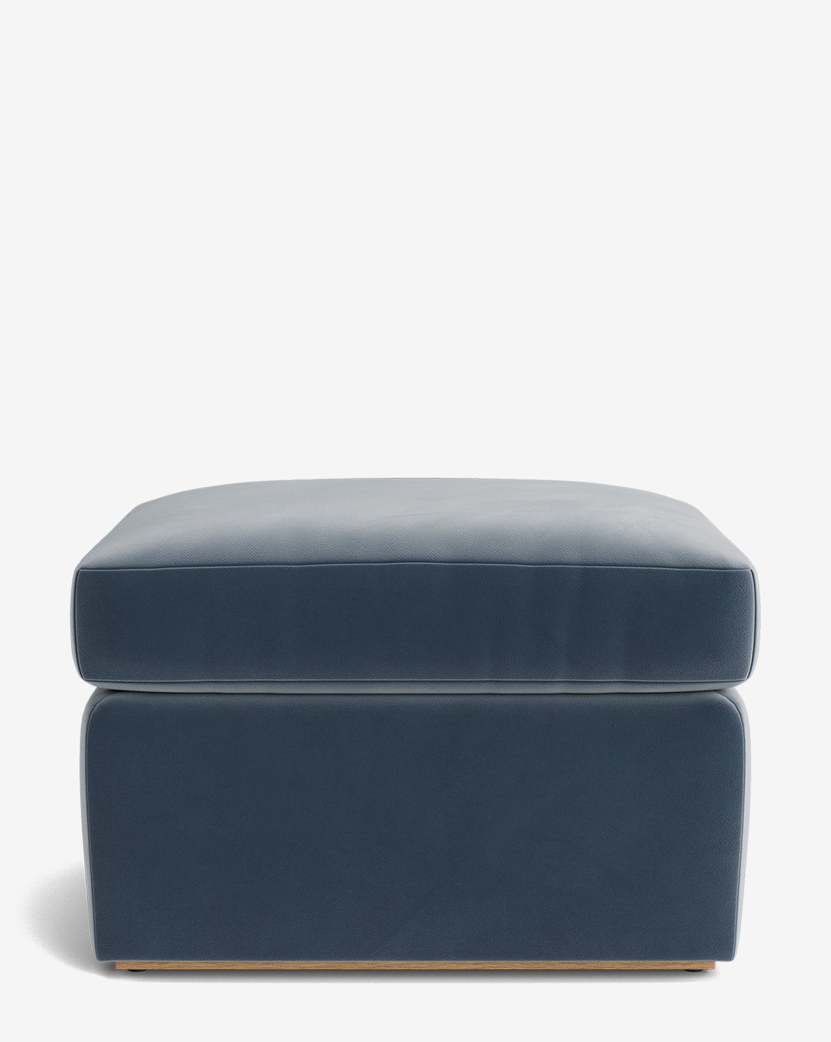 The Reese Ottoman is a handcrafted blue rectangular ottoman featuring smooth upholstery and a down-wrapped cushion, shown from the front on a plain white background by McGee & Co.