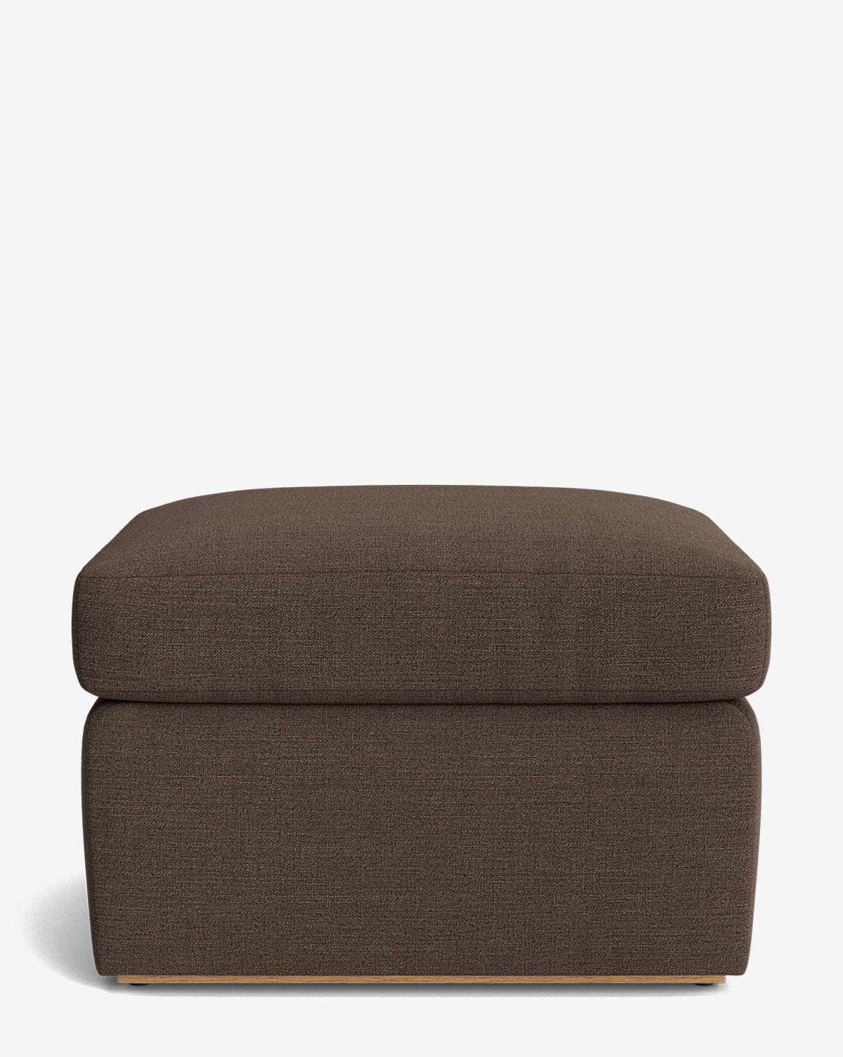 The Reese Ottoman features a rectangular silhouette in dark brown, a handcrafted build, and a plush down-wrapped cushion top with a simple, modern design. Shown against a plain white background by Vendixs