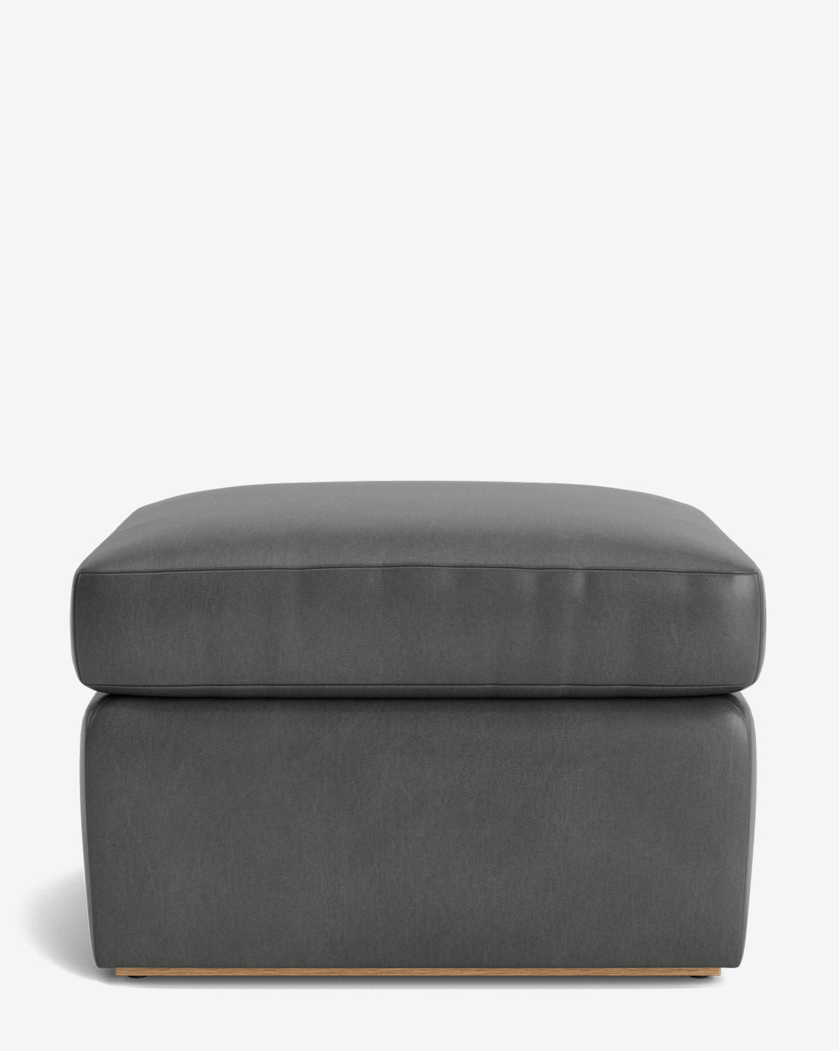 The Reese Ottoman is a modern, rectangular piece in dark gray with a down-wrapped cushion and minimalist design, shown against a plain white background, by Vendixs