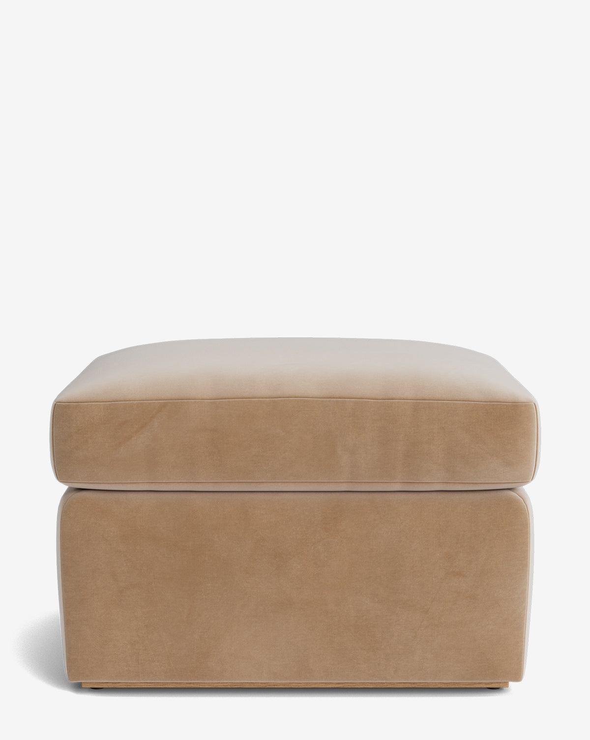 The Reese Ottoman is a rectangular, light brown ottoman with a soft, down-wrapped cushion top and smooth sides, handcrafted and featured against a plain white background by McGee & Co.