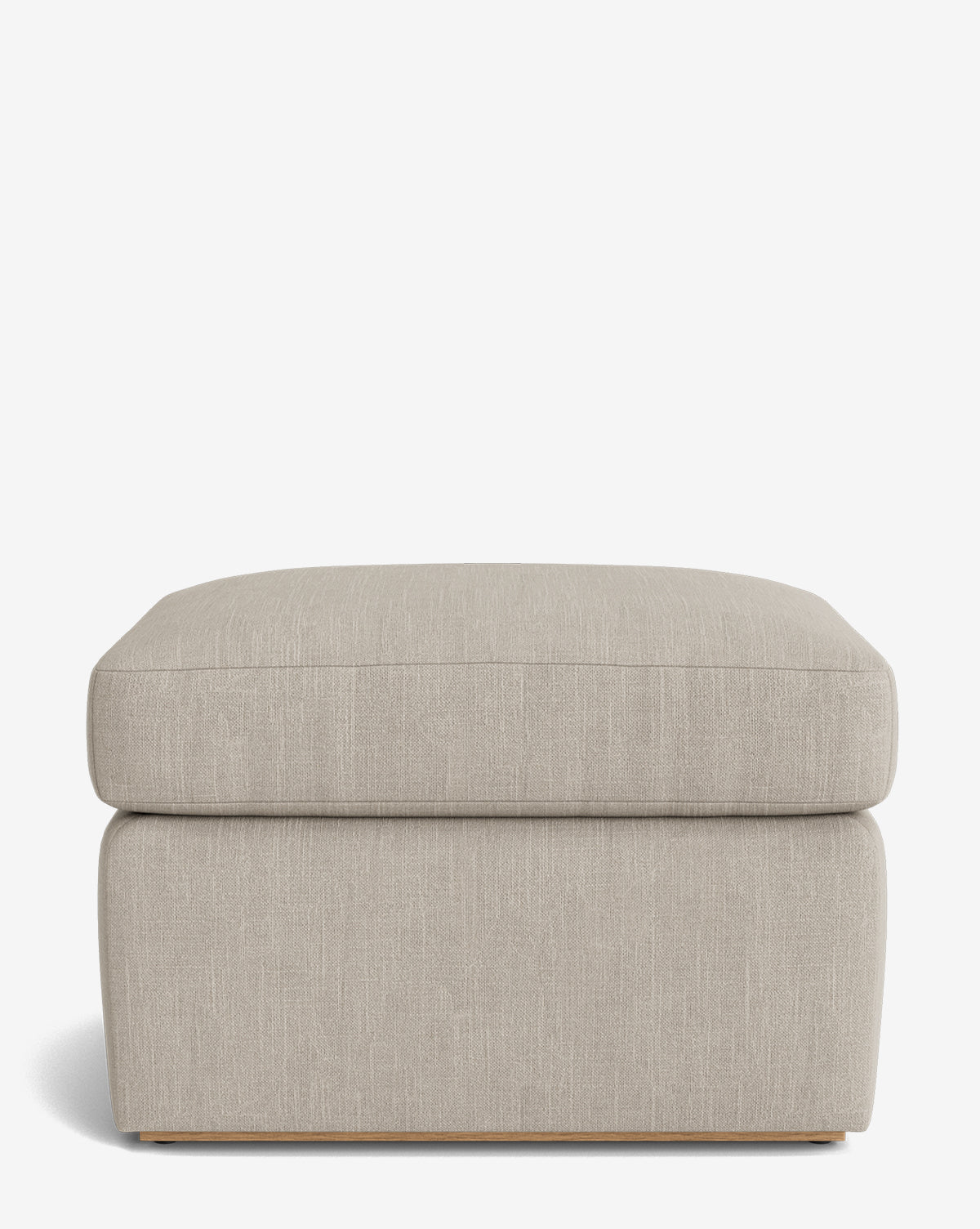 The Reese Ottoman is a handcrafted rectangular ottoman with a down-wrapped cushion top and subtle wooden base in light beige, displayed on a plain white background, by McGee & Co.