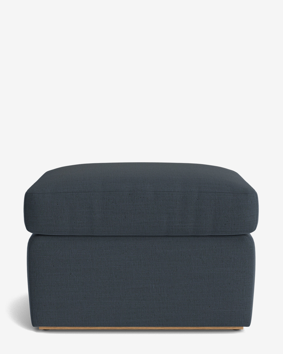The Reese Ottoman is a modern, rectangular handcrafted piece upholstered in dark blue fabric with clean lines, a down-wrapped cushion, and a low wooden base, shown against a plain white background by Vendixs