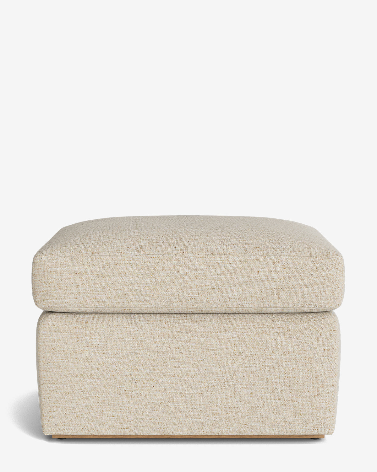 The Reese Ottoman is a rectangular, handcrafted piece in beige with a soft down-wrapped cushion and simple modern design, displayed on a white background by McGee & Co.