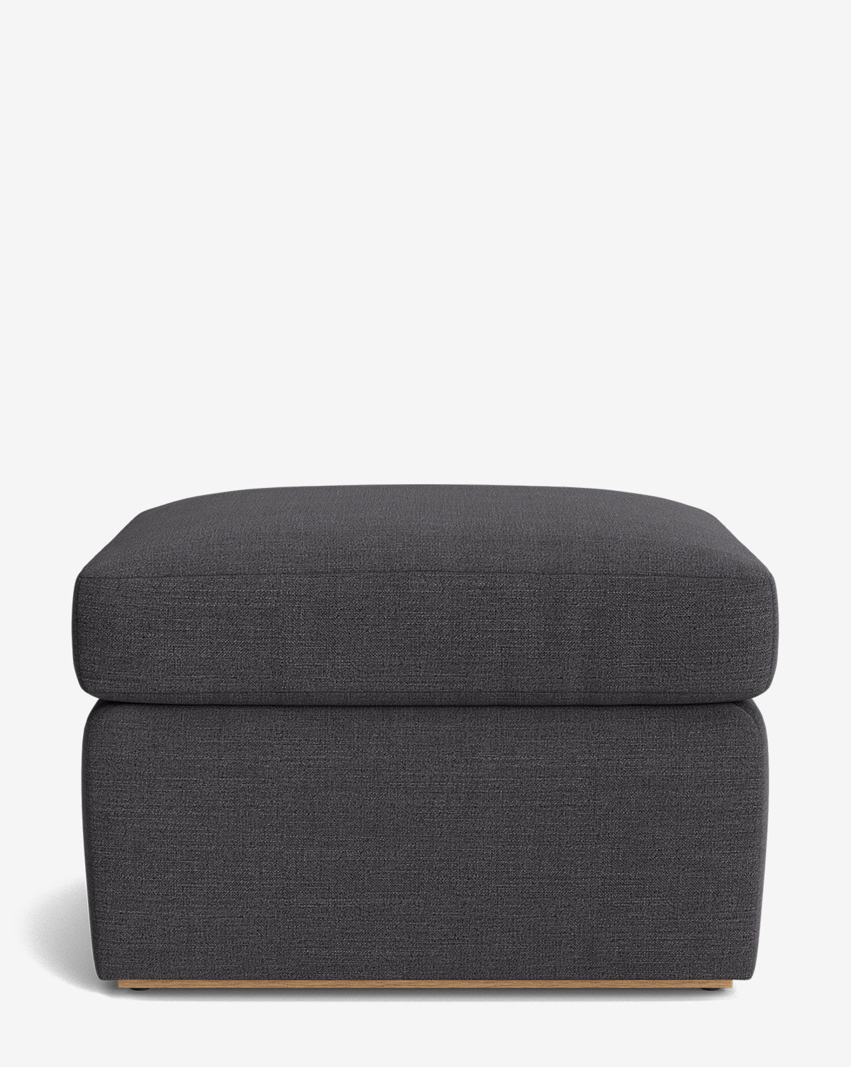 The Reese Ottoman is a modern, rectangular ottoman in dark gray with a down-wrapped cushion and clean lines, shown on a plain white background by McGee & Co.