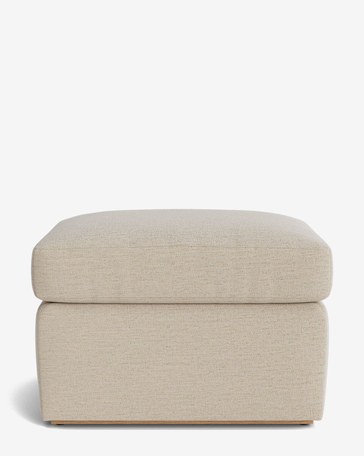 The Reese Ottoman is rectangular and beige with a down-wrapped cushion and a simple, modern design, shown against a plain white background, by McGee & Co.