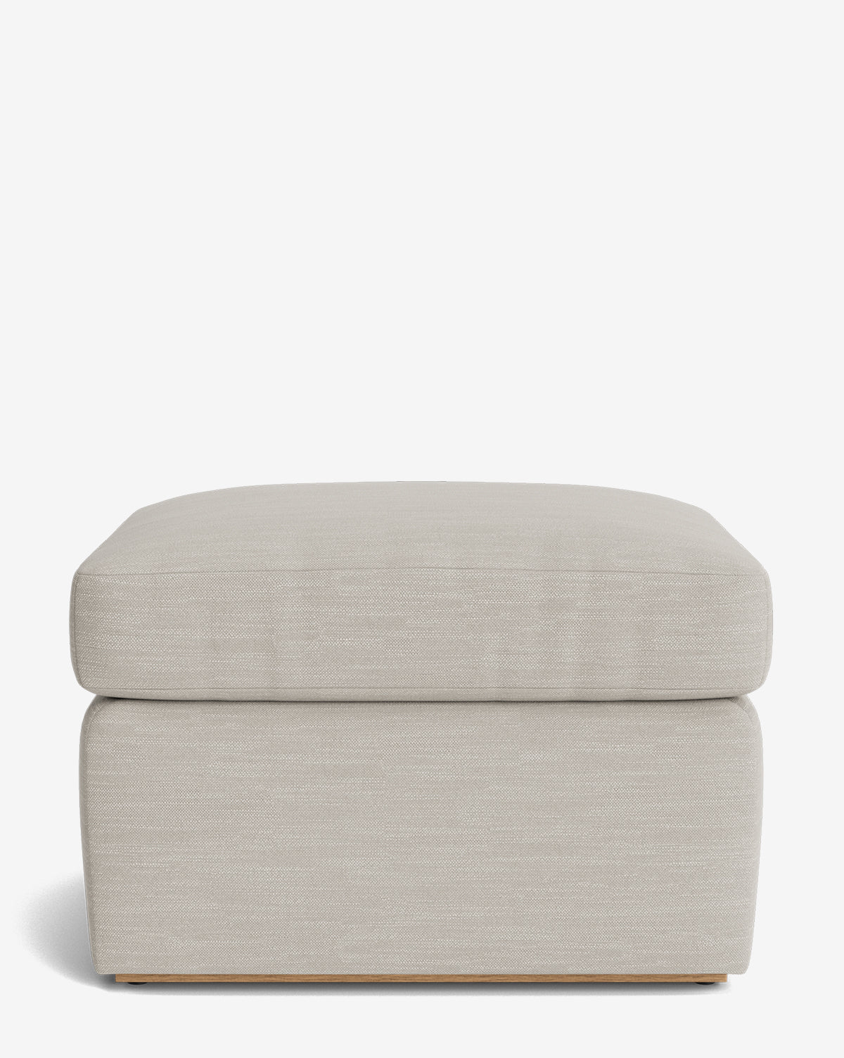 The Reese Ottoman is a handcrafted, square ottoman with light beige upholstery, a down-wrapped cushioned top, and a minimal visible base, designed in a simple, modern style by McGee & Co.