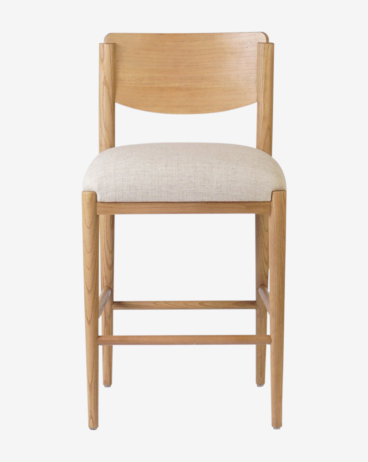 The Four Hands Reverie Stool features a natural wood frame, curved backrest, and cushioned beige fabric seat. Photographed from the front against a white background, it’s ideal for bringing warmth to your kitchen. Vendixs