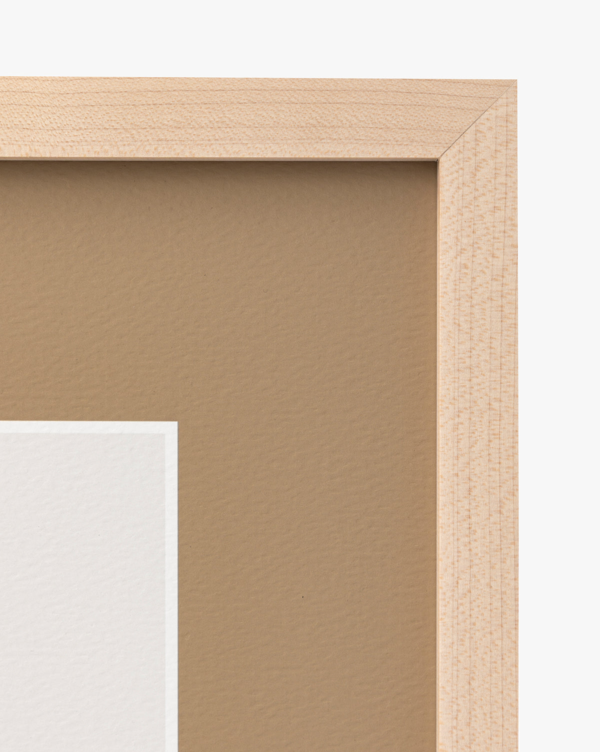 A close-up of the top right corner of a Rex maple frame, featuring part of a matted image with a brown background and white border—ideal for displaying nursery wall art, by Vendixs
