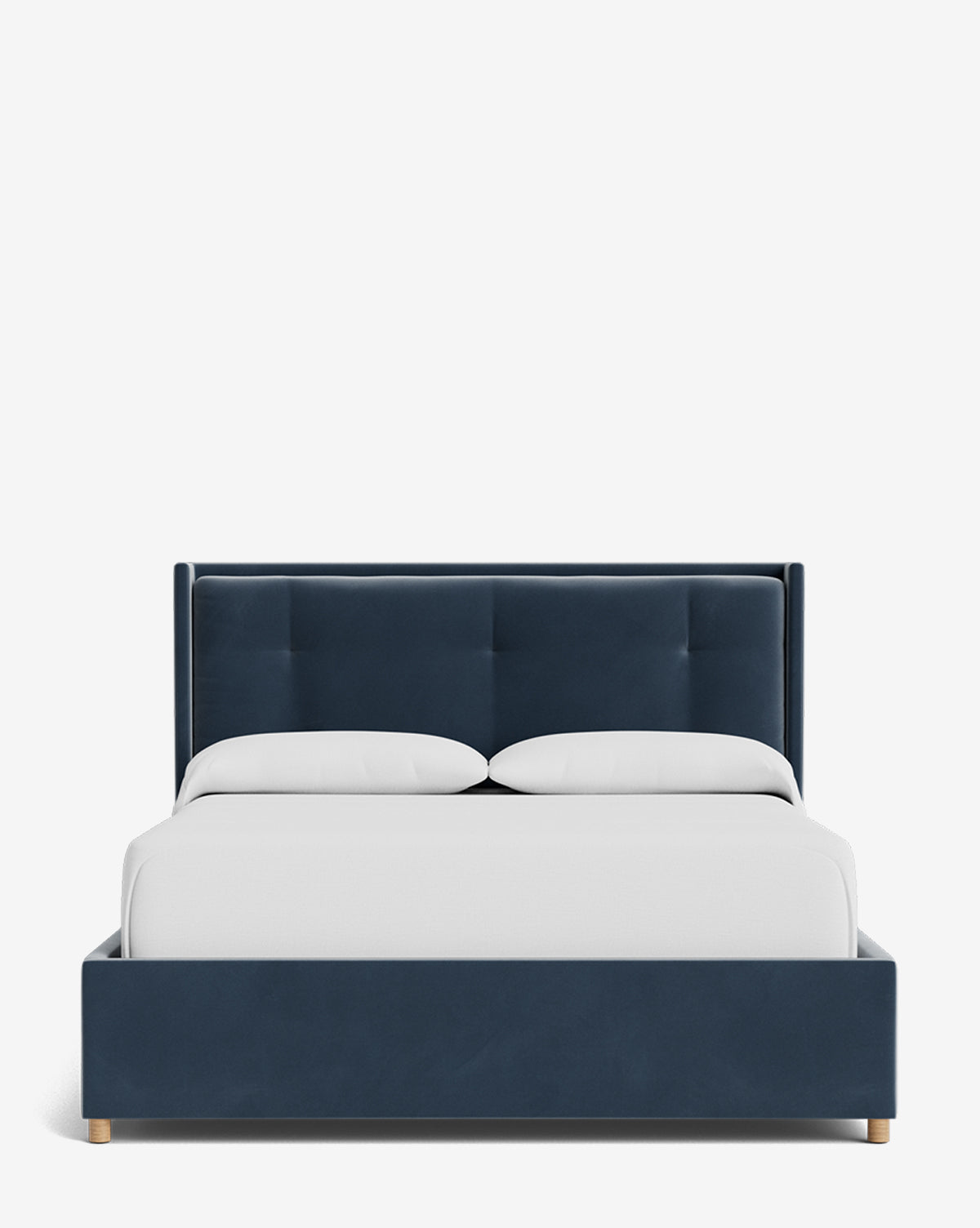 The Ria Bed Low Headboard features a navy blue upholstered frame, a tufted headboard, two white pillows, and a white blanket, all set against a plain white background by Vendixs