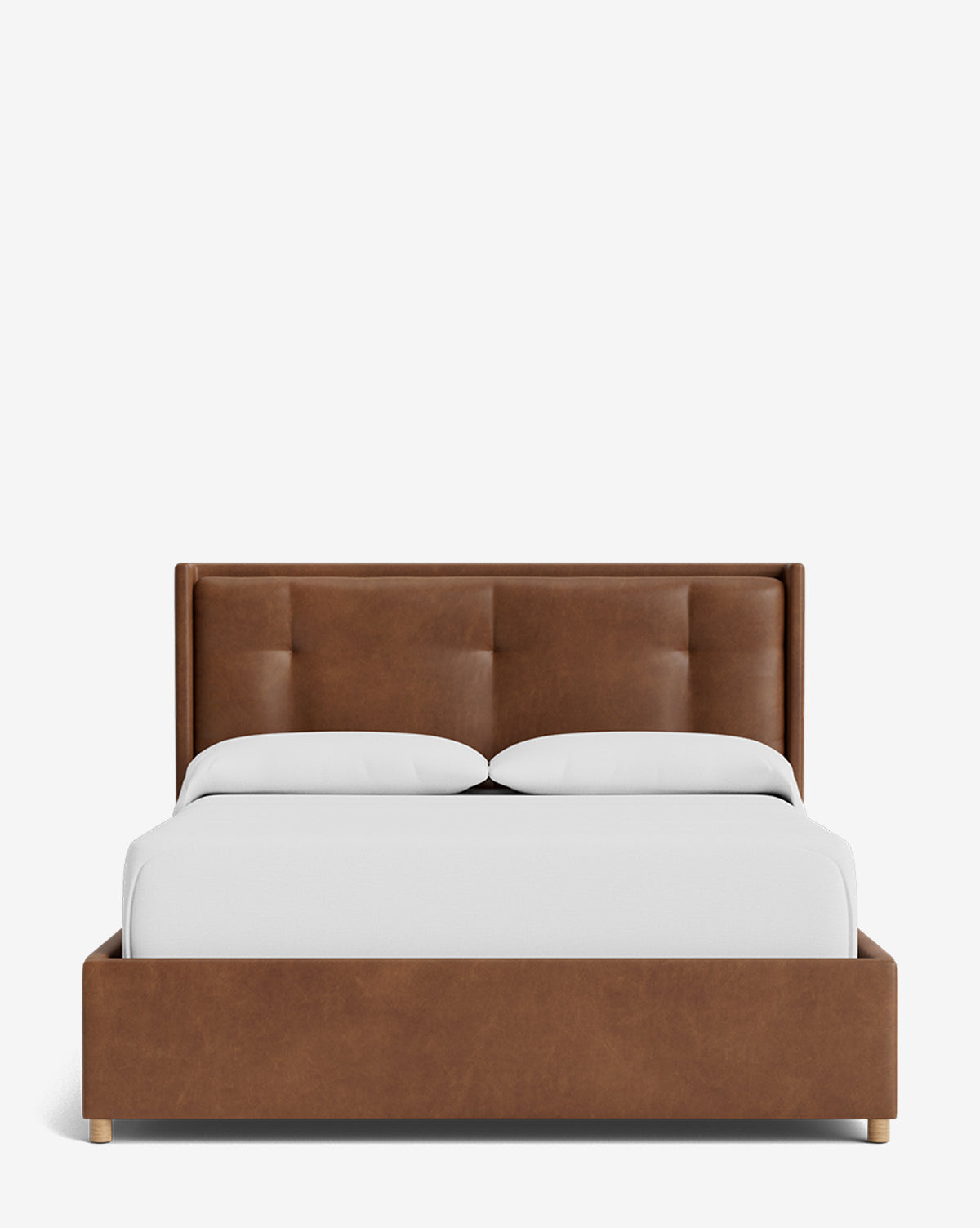 The Ria Bed Low Headboard is a modern upholstered bed with a brown, tufted headboard and frame, styled with crisp white bedding and two pillows on a plain white background, by Vendixs