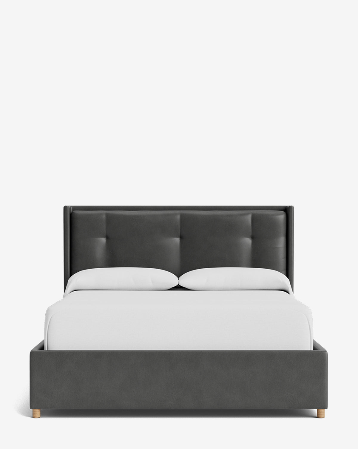 Front view of the Ria Bed Low Headboard, a modern dark gray upholstered bed with a tufted headboard and frame, two white pillows, and a crisp white duvet on a plain white background, by Vendixs