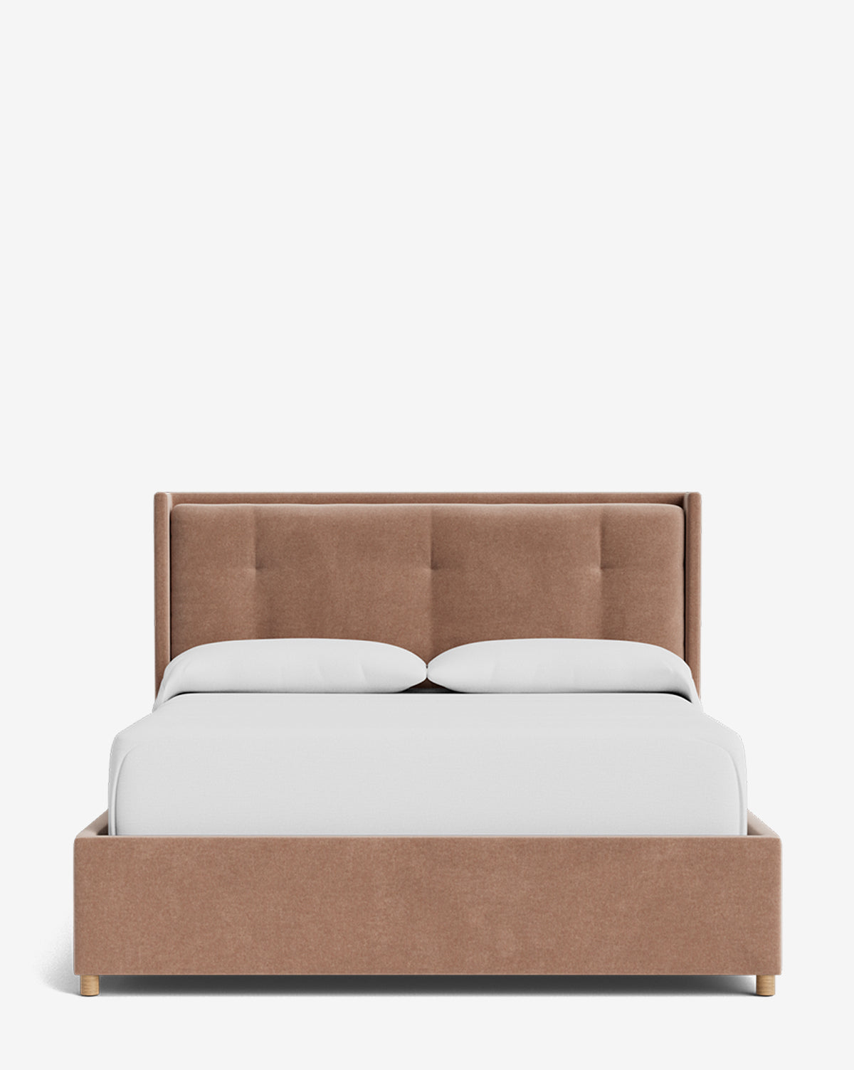 The Ria Bed Low Headboard features a modern light brown upholstered frame with a tufted headboard, paired with two white pillows and a neatly made white comforter, displayed on a plain white background by Vendixs