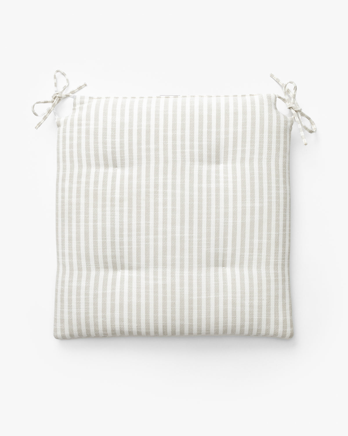 The Credence Romany Counter Stool Cushion is a square linen cushion with beige and white stripes, four tufted points, and two pairs of ties—ideal for enhancing your Romany Counter Stool. Shown on a white background. Vendixs