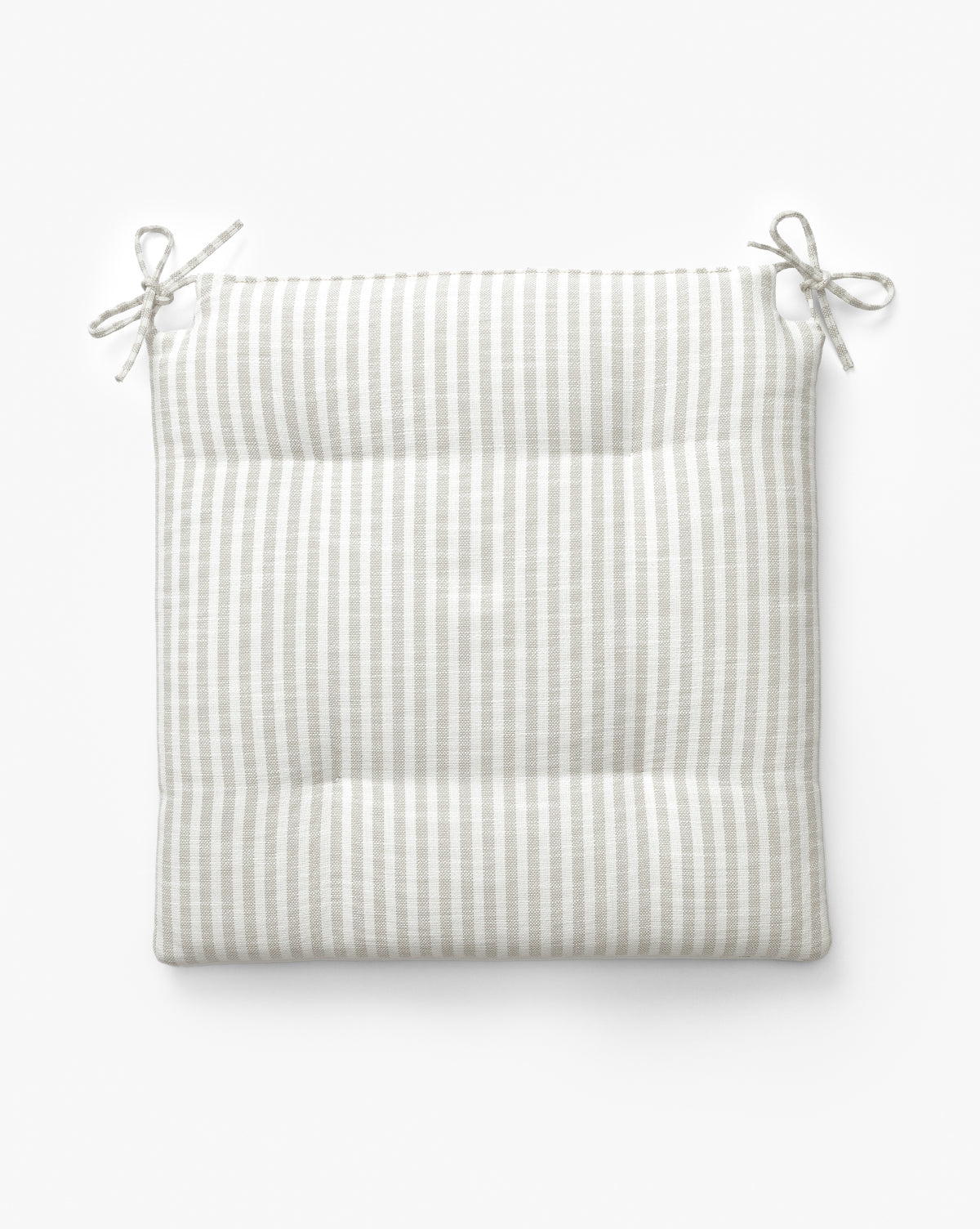 The Credence Romany Dining Chair Cushion is a square, padded linen cushion with light gray and white stripes and two pairs of top-corner ties, ideal for adding comfort and style to your chair. Shown on a white background. Vendixs