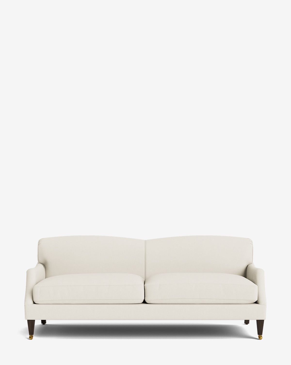The Rowley Sofa 85 is a modern, cream-upholstered, hand-crafted sofa featuring two seat cushions, a low backrest, and dark wood legs with brass caster wheels, displayed against a plain white background by Vendixs