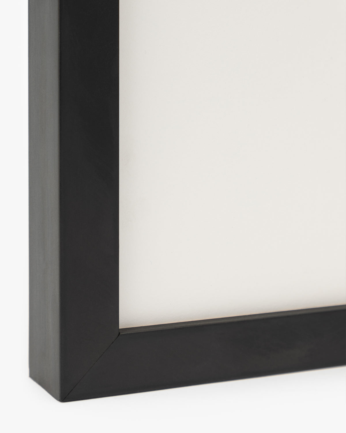 Close-up of the bottom left corner of a black wood frame with a white background—perfect for displaying Sail Away watercolor wall art or small ship-themed pieces, by Vendixs