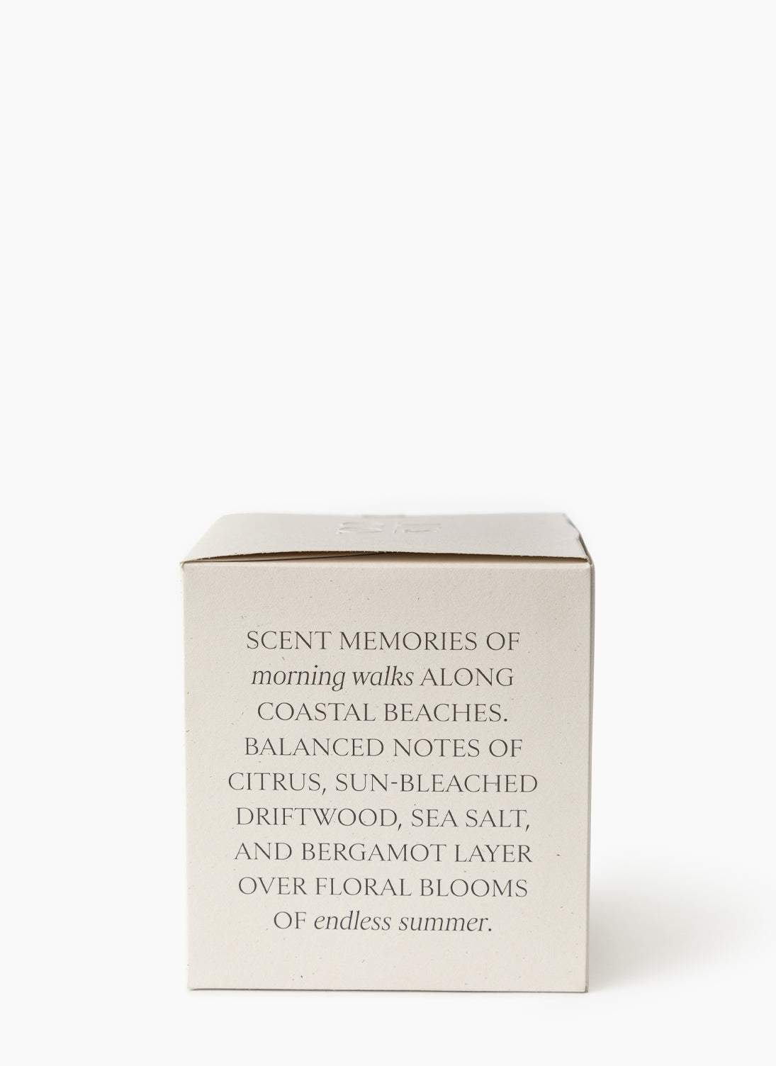 A beige box with black text describes the Salt & Sea Candle, evoking morning coastal walks with balanced notes of citrus, sea salt, driftwood, and bergamot over floral blooms—a soy wax candle for endless summer, by Vendixs