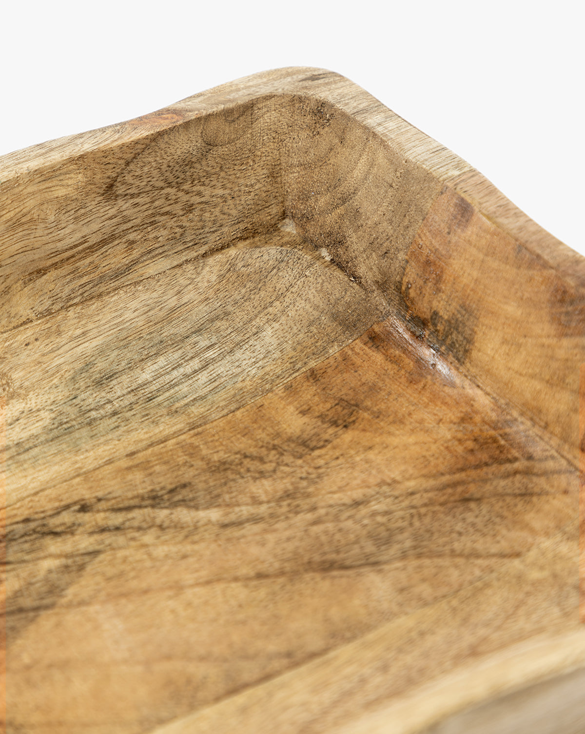 Close-up view of the corner of the Scalloped Wood Tray, highlighting its smooth handcrafted mango wood texture and natural grain patterns on a white background, by McGee & Co.
