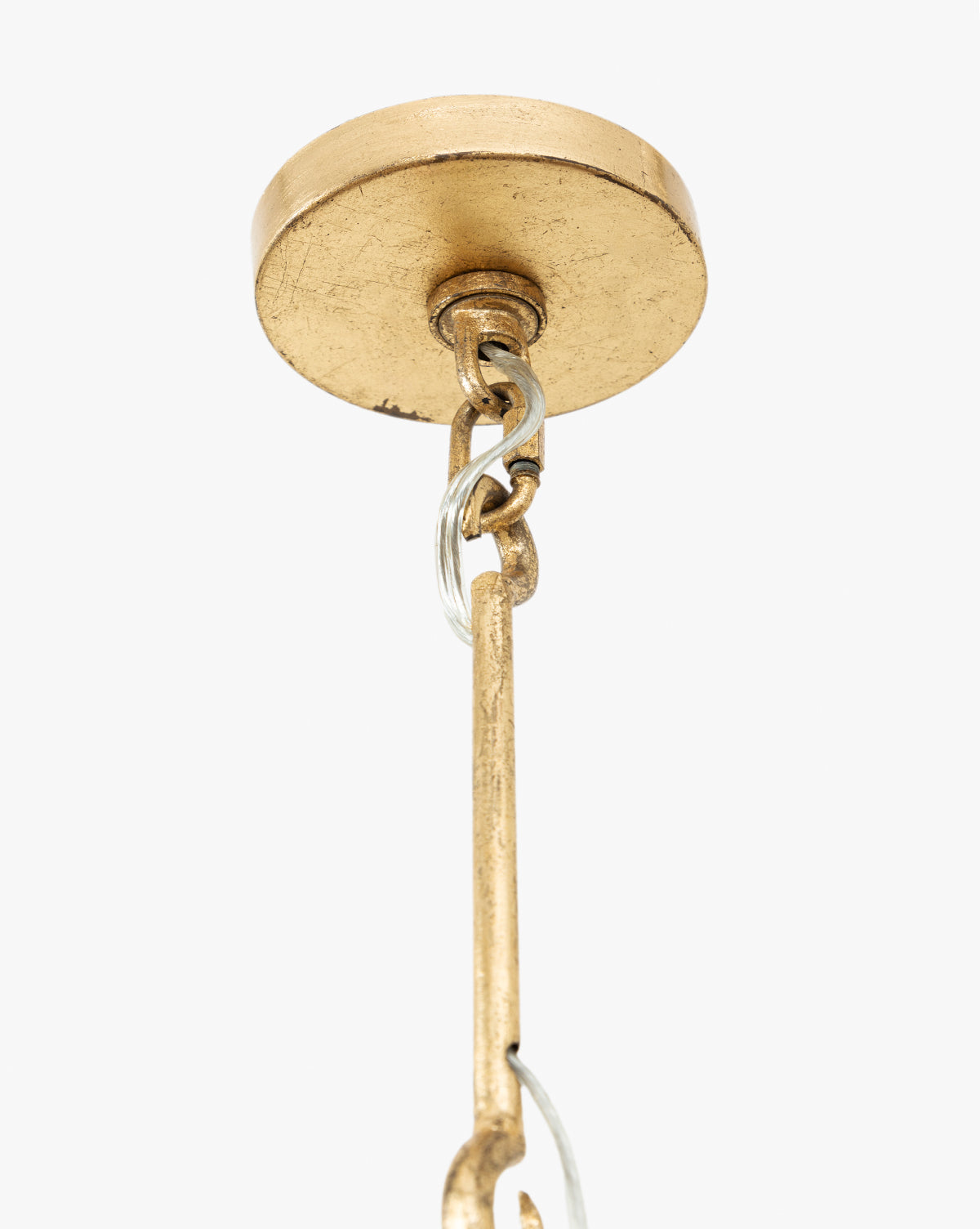 Close-up of the Scarlett Pendants gold leafed iron ceiling canopy, featuring an attached metal chain and rod, set against a plain white background, by Vendixs
