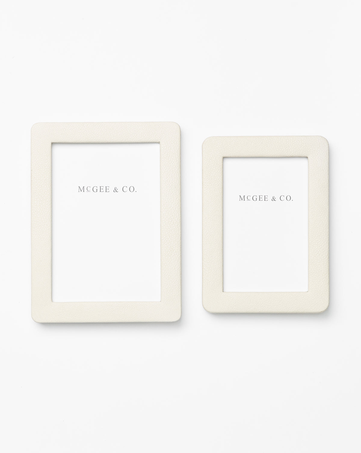 Two cream-colored Shagreen Picture Frames in different sizes, featuring shagreen leather details and white Vendixs inserts, are displayed on a plain white background for an elegant look.