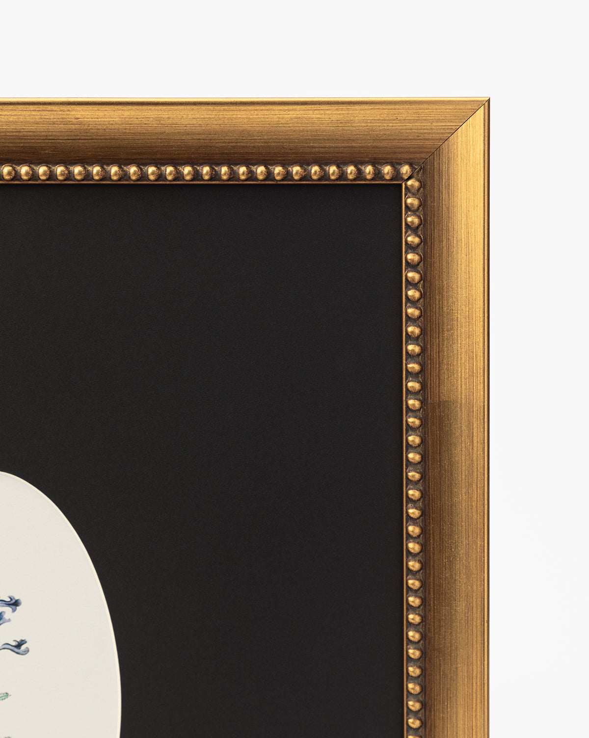 A close-up of the gold beaded frame corner showcases Single Blooms 3: a white oval botanical print with a black mat and floral detail—perfect for vintage wall art decor, by Vendixs