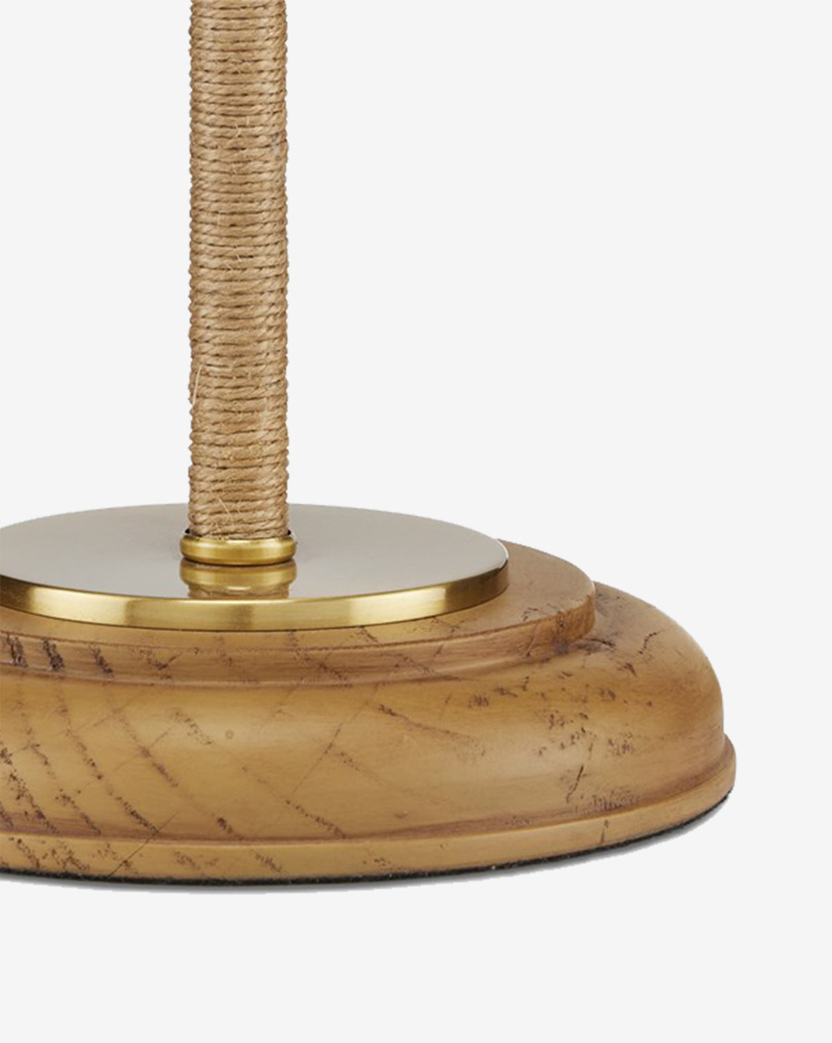 A close-up of the Sirocco Desk Lamp highlights its round wooden base with visible scratches and grain, an antique brass accent at the top, and a pole wrapped in natural rope, by Vendixs