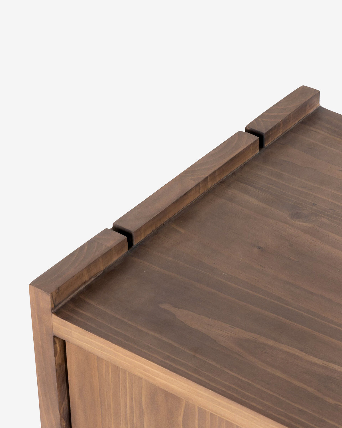 Close-up of the Sloane Sideboard’s corner, highlighting its solid pine build, smooth finish, visible natural wood grain, and minimalist design with three raised rectangular sections along the edge, by Vendixs