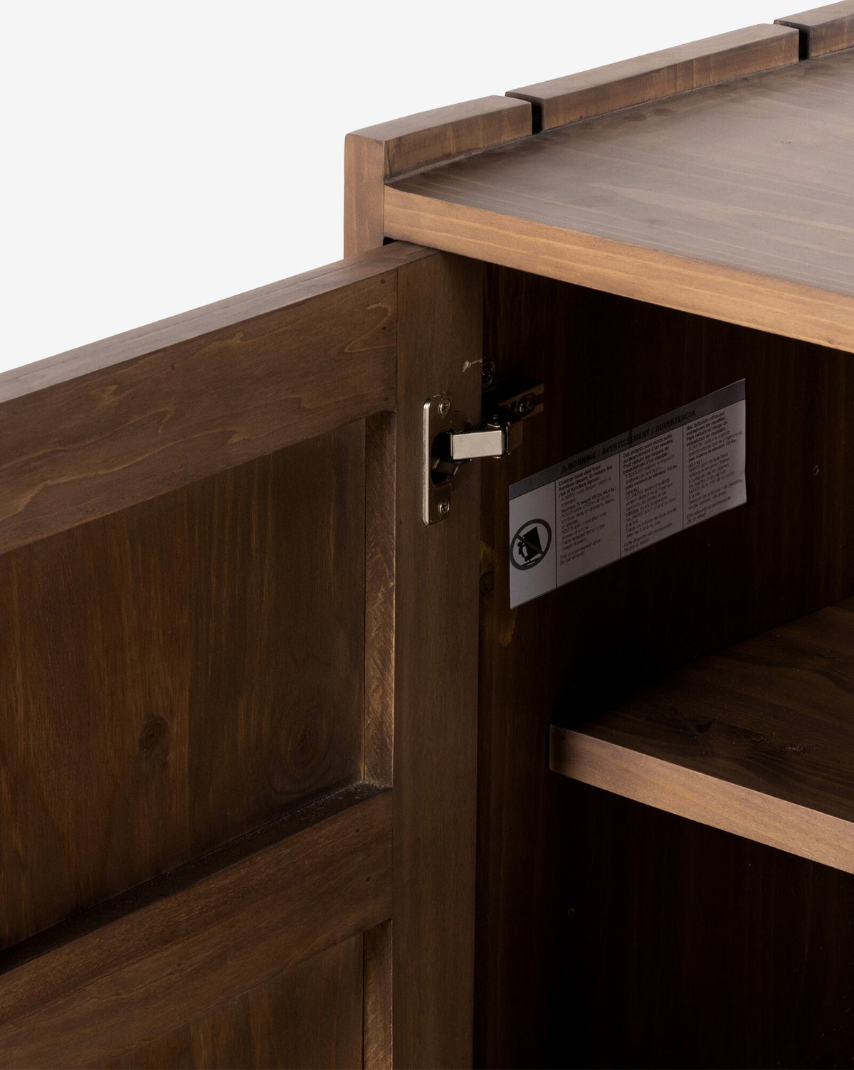 Close-up of the Sloane Sideboard’s interior with an open door, highlighting the metal hinge, interior shelf, and a label featuring text and symbols affixed to the side by Vendixs