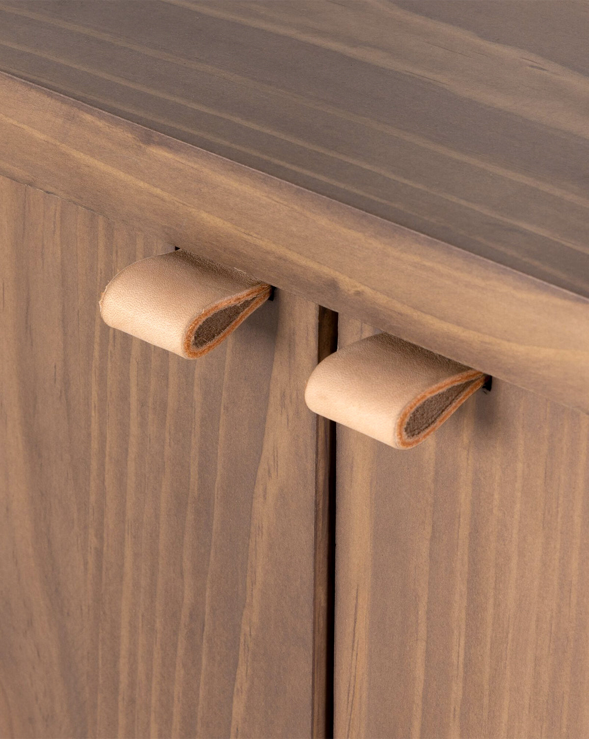Close-up of two tan leather pulls on the Sloane Sideboards natural wood grain doors—a stylish upgrade for European midcentury or solid pine interiors, by Vendixs