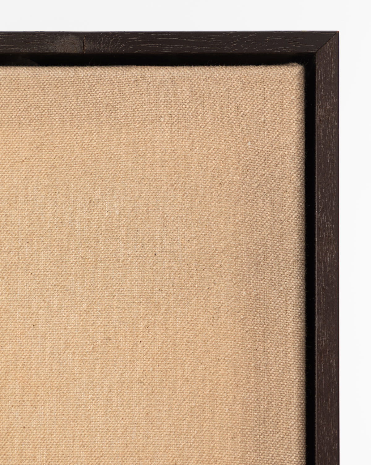 Close-up of the top left corner of Smokey Pasture, an empty beige canvas in a dark wooden frame, highlighting wall art texture against a white background, by McGee & Co.