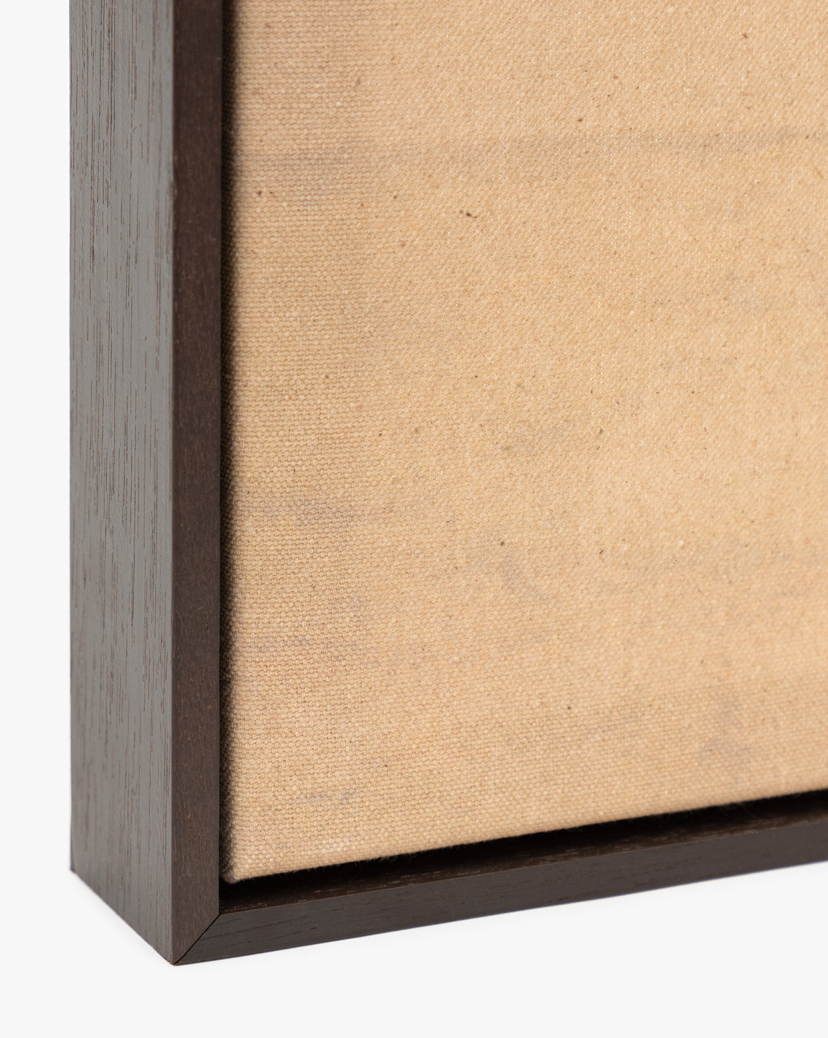 Close-up of the corner of Smokey Pasture—a blank, textured beige canvas in a dark wooden frame—ideal as minimalist wall art or as the base for your next country landscape giclee print, by Vendixs