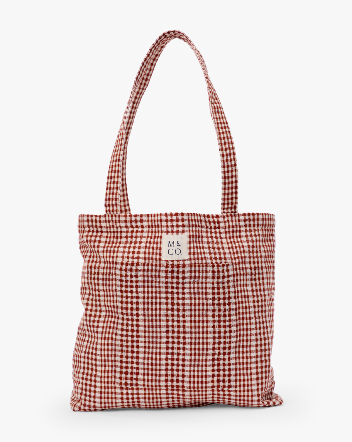 The Spencer Tote Bag is a red and white gingham bag with two handles and a small white label reading "M & CO." on the front, displayed against a plain white background, by Vendixs