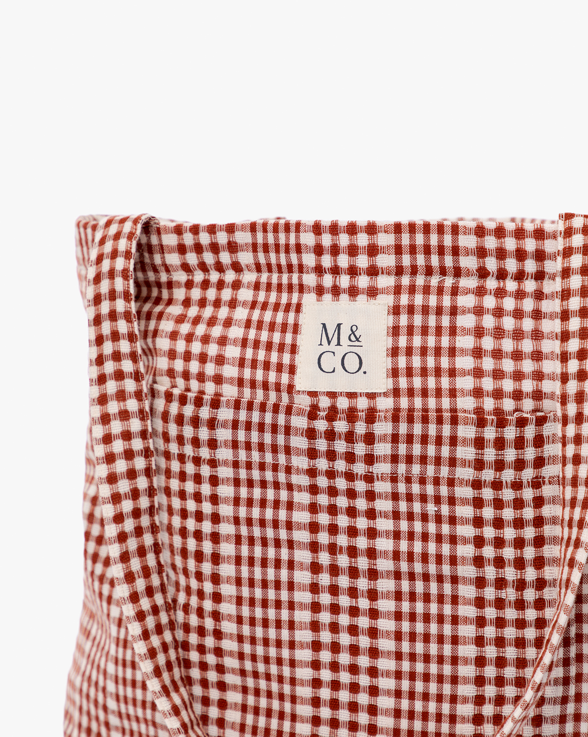 Close-up of the Spencer Tote Bag in red and white gingham with a visible “M & CO.” label stitched on the upper center, ideal for casual outings by Vendixs