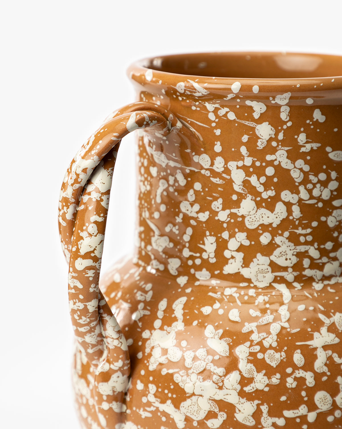 Close-up of the Splatter Verona Vase, a handmade ceramic jug with a single handle, featuring a brown base and white speckles, shown against a plain white background, by Vendixs