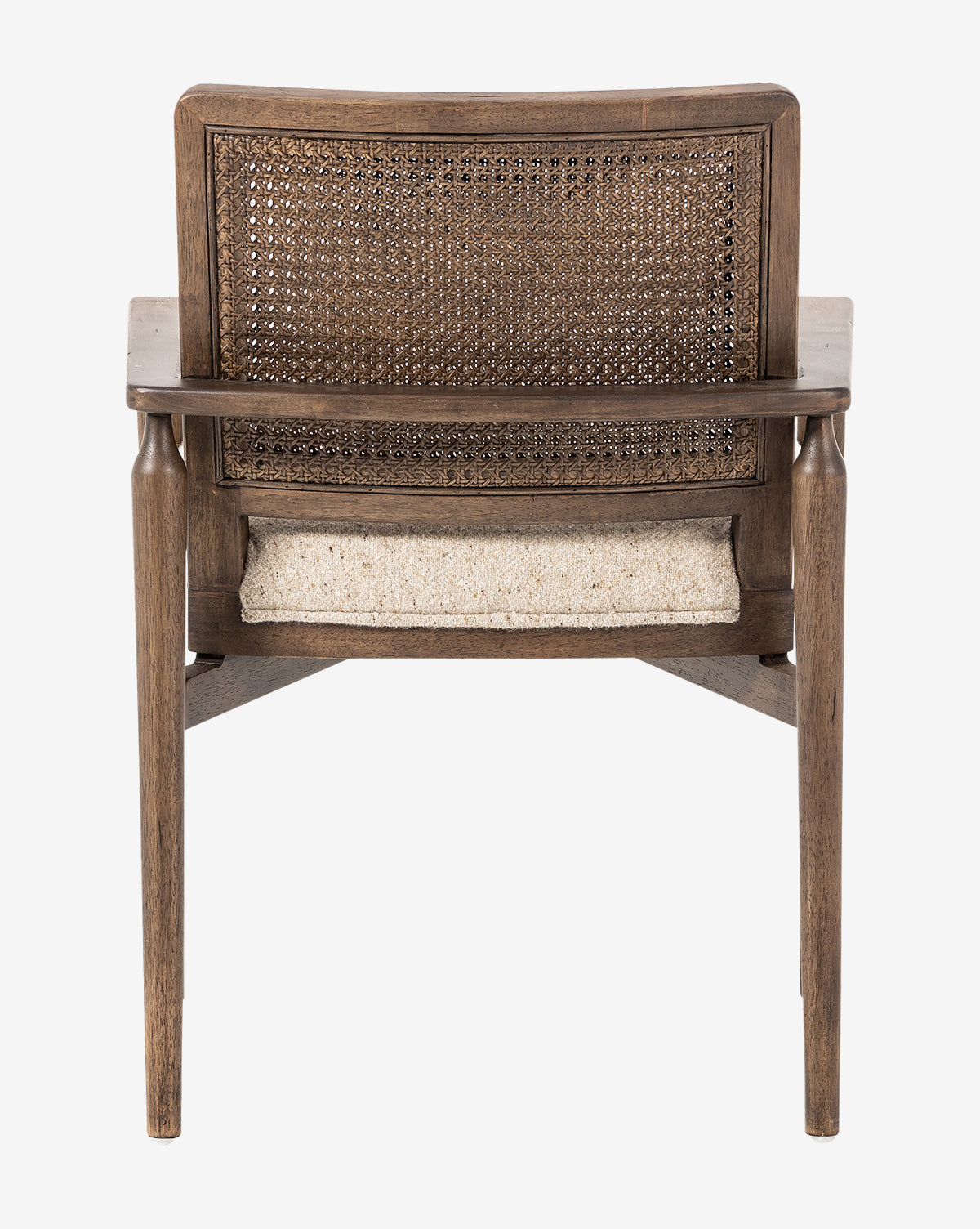 The Zalan Dining Armchair is shown from behind, highlighting its woven cane back, light-colored upholstered seat, and slightly angled legs by McGee & Co.