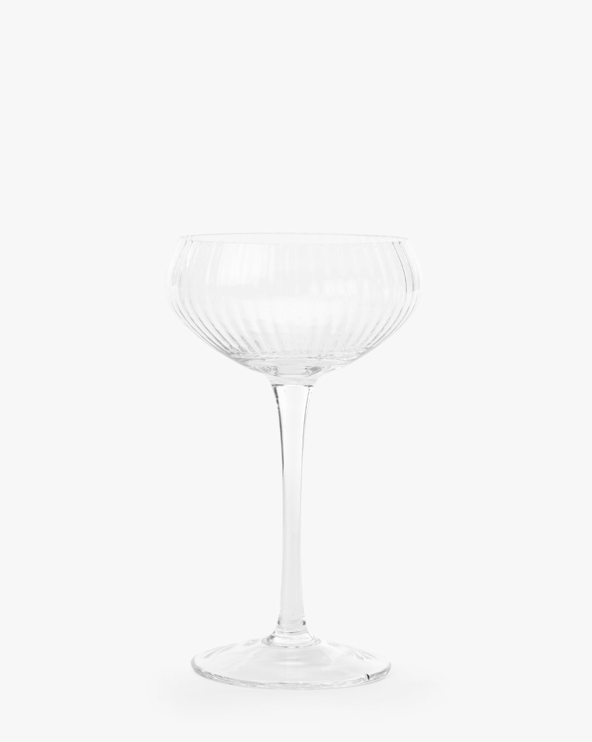 The Stemmed Champagne Glass features a clear, ribbed design with a wide bowl and long stem, embodying elegant glassware against a plain white background, by Vendixs