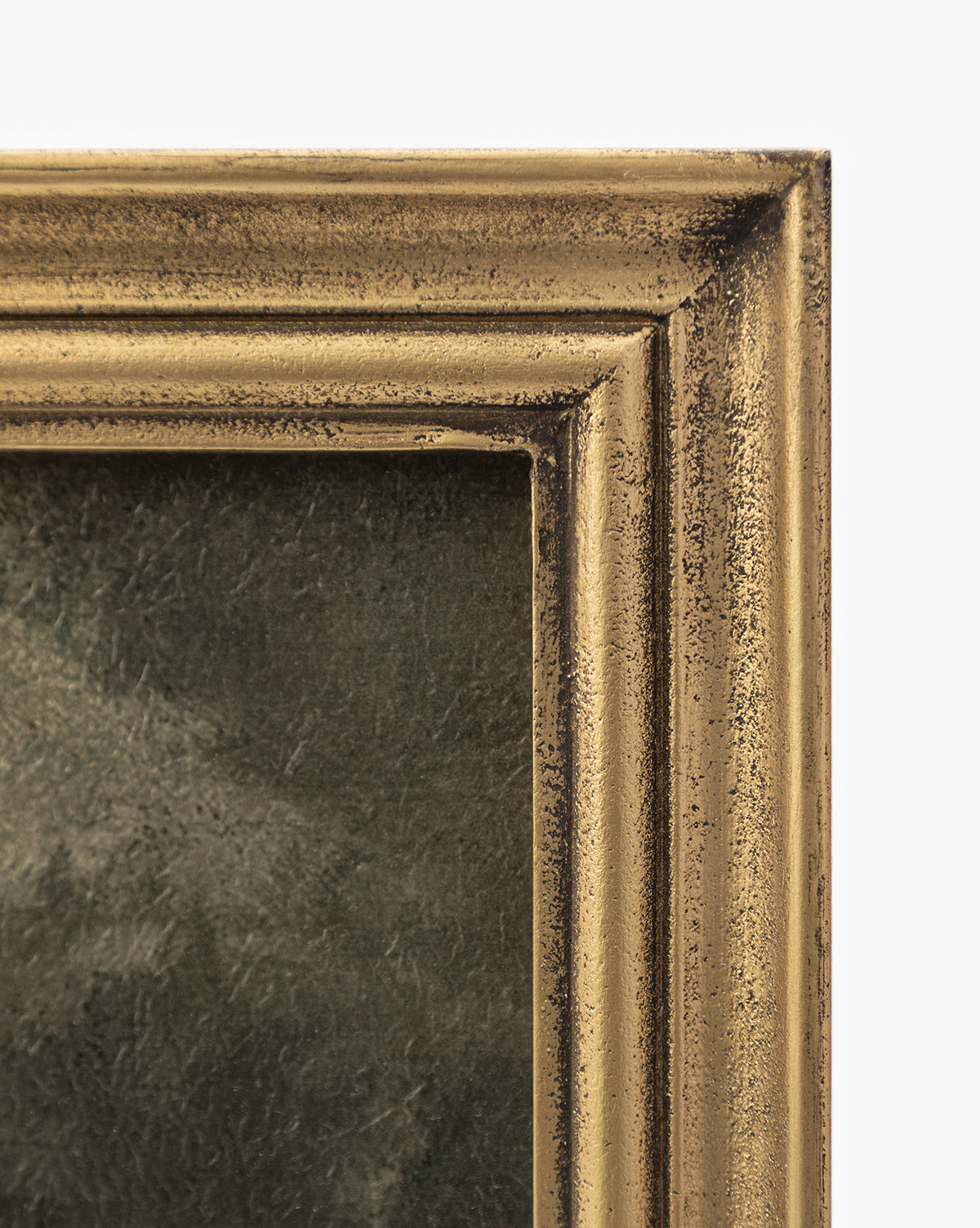 Close-up of the top right corner of a gold wood frame, its textured finish adding elegance. Inside, Storm on the Lake—a dark, moody artwork—appears against a plain white background, hinting at a dramatic landscape.