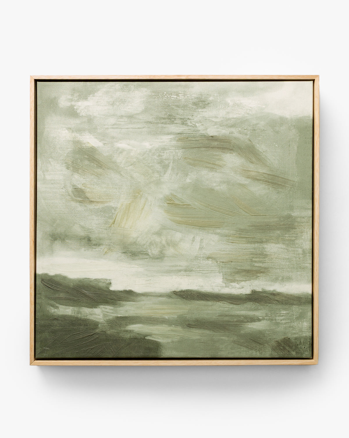 Stormy Sky Afternoon is an abstract painting in green and white with soft, blurred brushstrokes recalling a cloudy sky over a landscape. This framed wall art features light-colored wood for a modern accent, by Vendixs