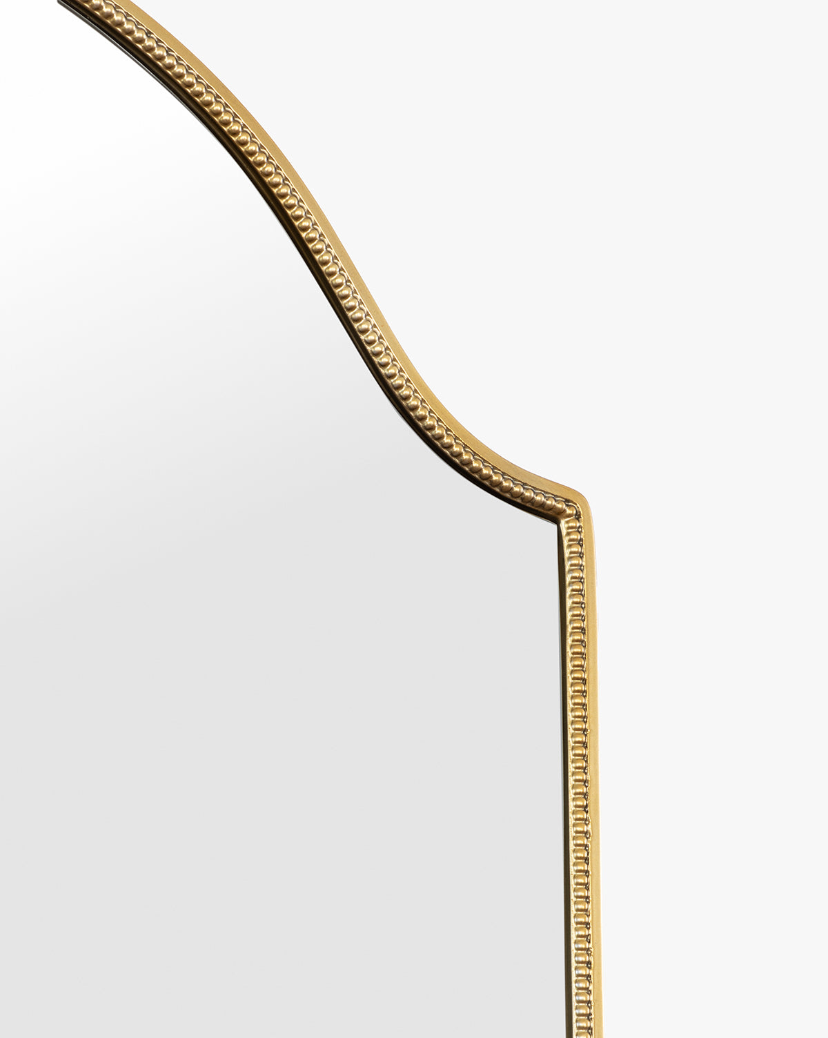 A close-up of the Sussex Floor Mirror shows its gold beaded, ornate frame and arched top set against a plain white background, by Vendixs