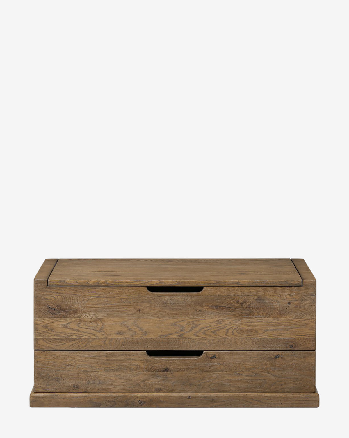 The Sutton Trunk is a rectangular wooden chest with a rustic weathered oak finish, two front drawers with cut-out handles, and a flat base. It is shown against a plain white background, by Vendixs