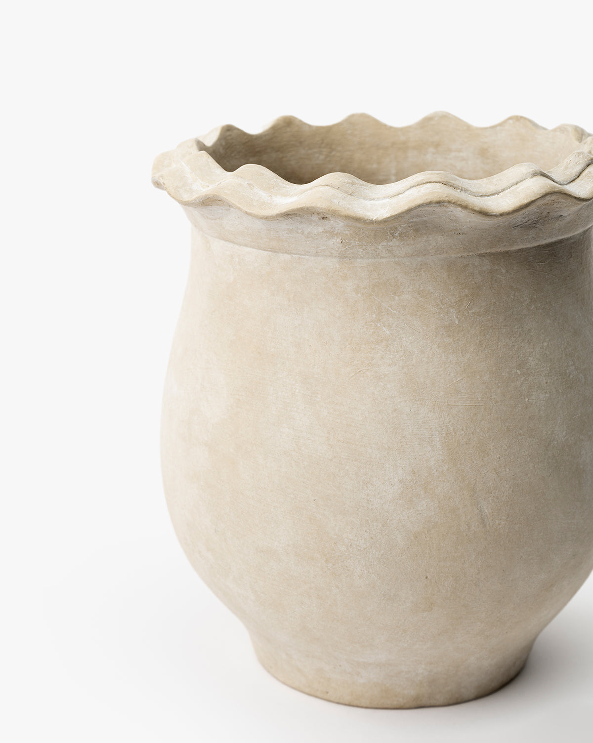 The Swansea Indoor Pot features a beige, wide-round body and wavy ruffled rim, ideal for indoor plant styling. Shown against a white background, by Vendixs