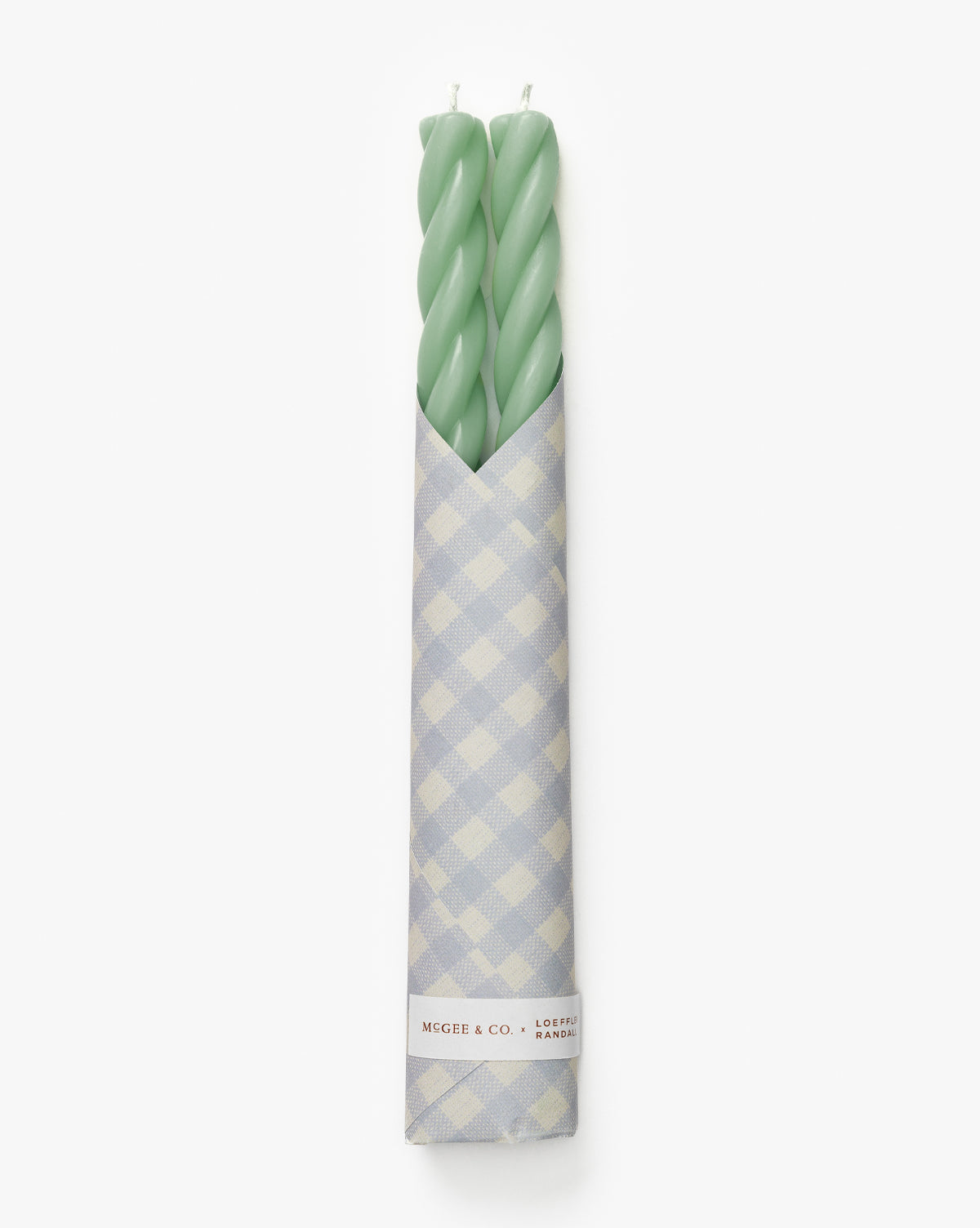 The Vendixs x Loeffler Randall Sybil Wax Taper Candles (Set of 2) in light green, wrapped in blue and white gingham paper, add a charming designer touch to your decor, by Vendixs