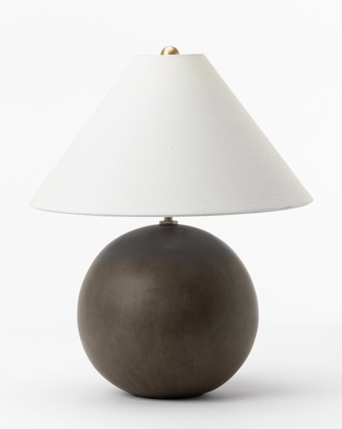 The Tess Ceramic Table Lamp features a round dark brown base and a wide white cone-shaped shade, shown against a plain white background by Vendixs