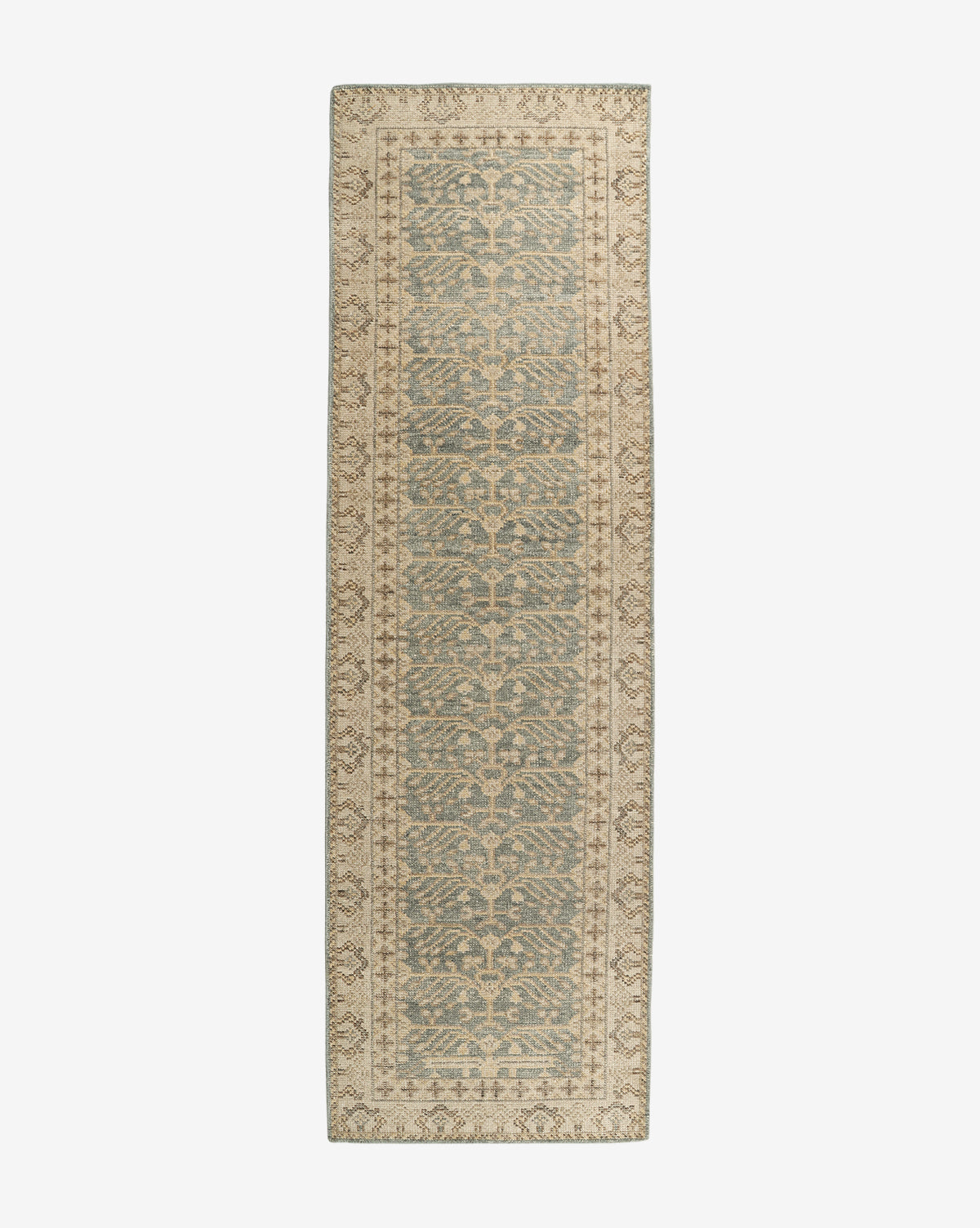 The Thames Hand-Knotted Rug is a long, narrow runner featuring a vintage, distressed look with muted blue and beige floral vines and a light beige border—perfect for adding an antique-inspired touch of luxury to any room, by Vendixs
