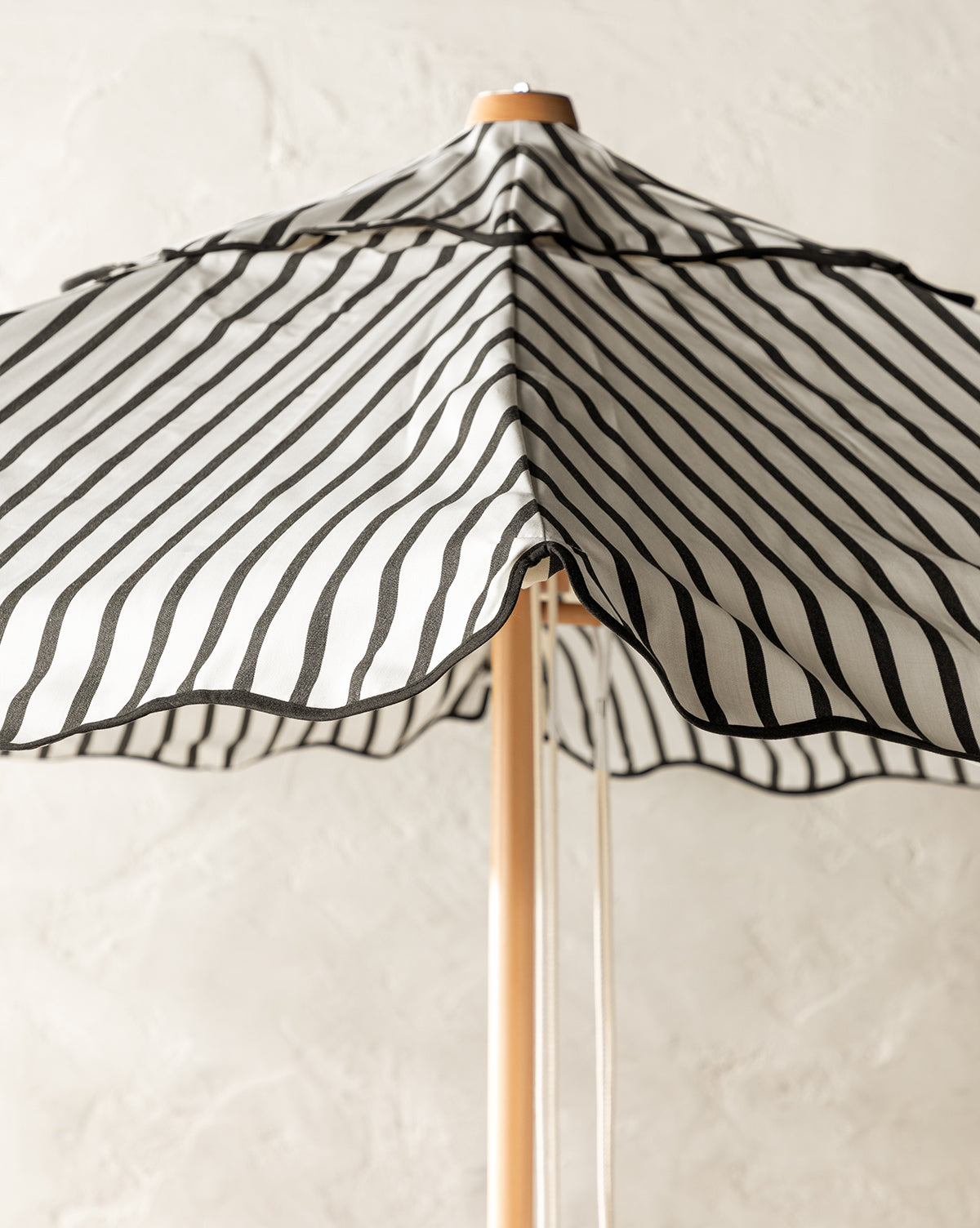 Black and white striped patio umbrella with bamboo base from Vendixs