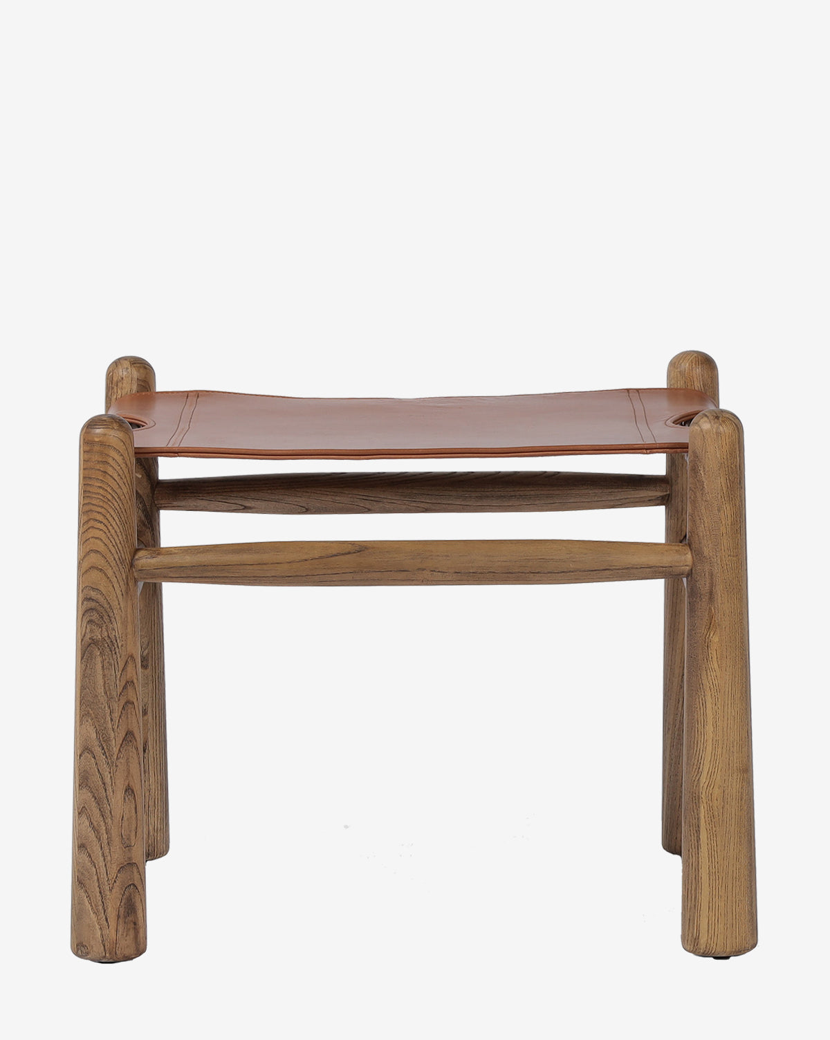 The Four Hands Tierney Ottoman features solid wood construction and a top grain leather seat, rounded legs, and simple, sturdy design, displayed against a plain white background. Vendixs
